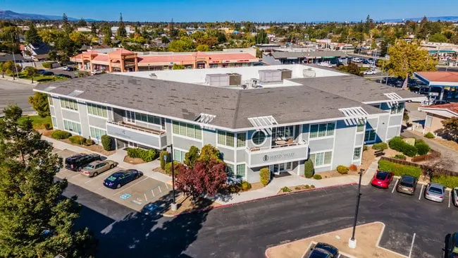 Aerial view of the building and its parking lot