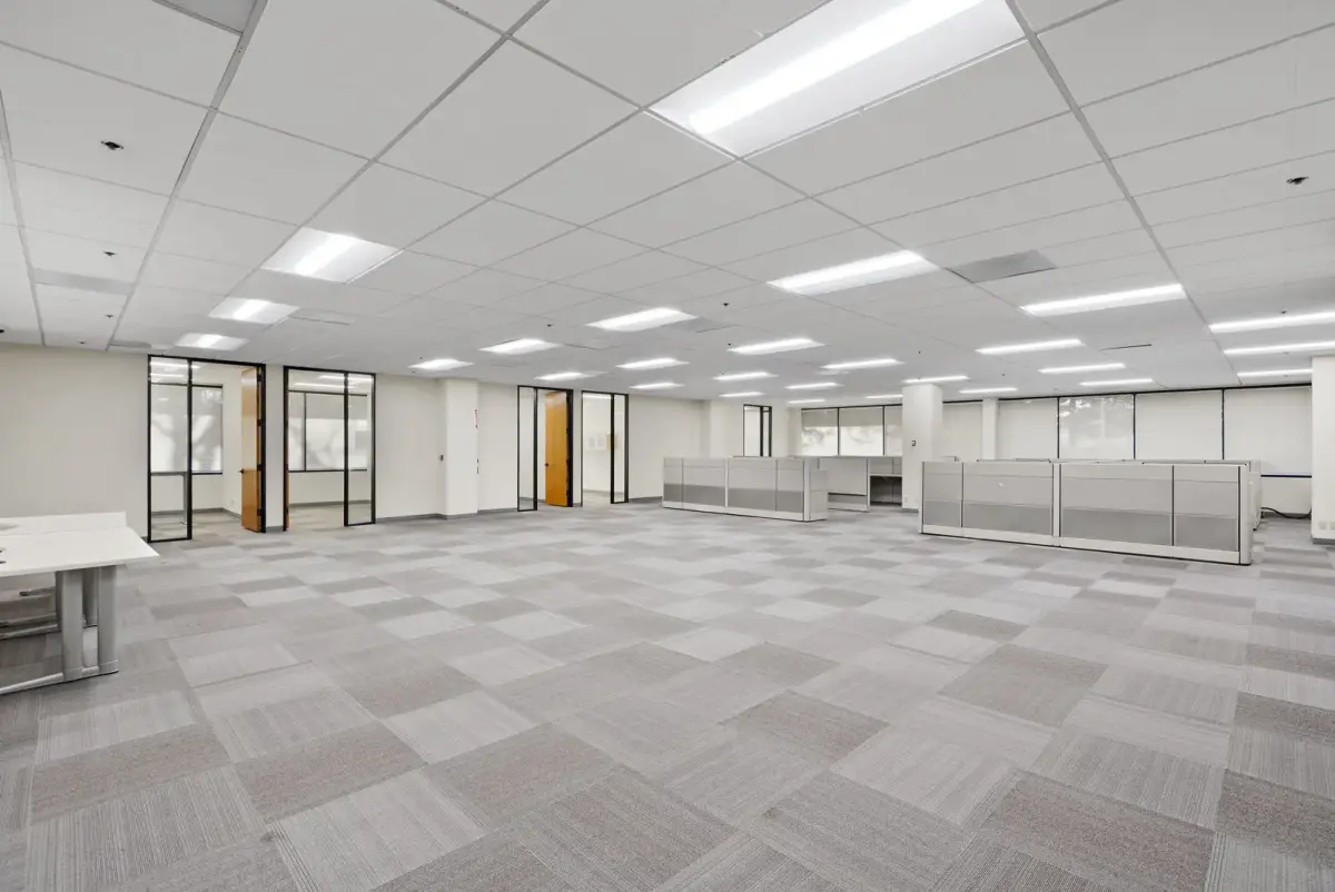 An open work area at 3235 Kifer Rd with carpet tile and glass-front offices